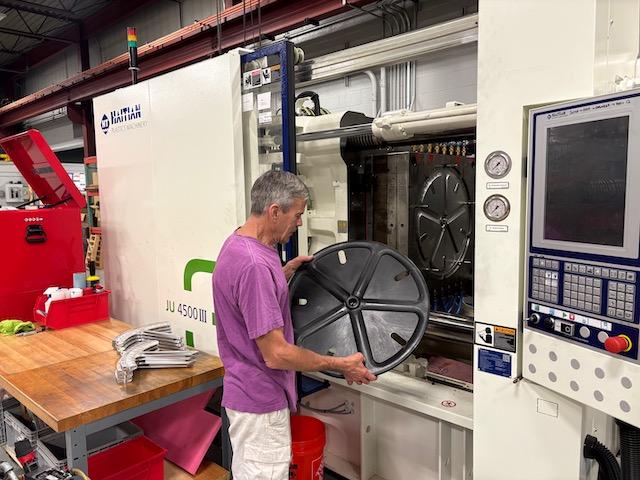 Large Injection Molding Machine at Forward Motion Technologies manufacturing facility - Premium wheel production equipment